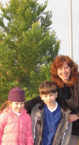 Meri and her children pose in front of the Wellingtonia she helped plant at the Triangle